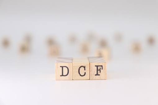 DCF acronym. Concept of Discounted Cash Flow written on wooden cubes isolated on white backround.