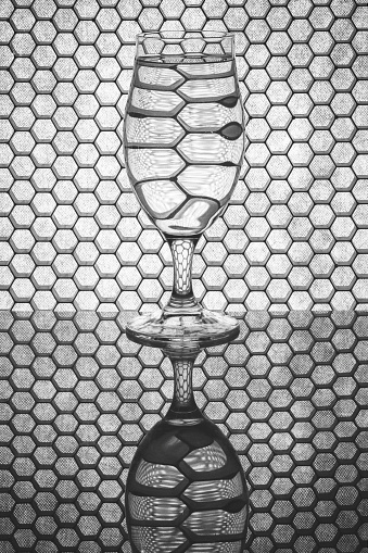 A glass of liquid with a honeycomb background