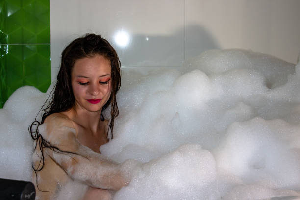 istock Young woman in a tub in foam 2150853371