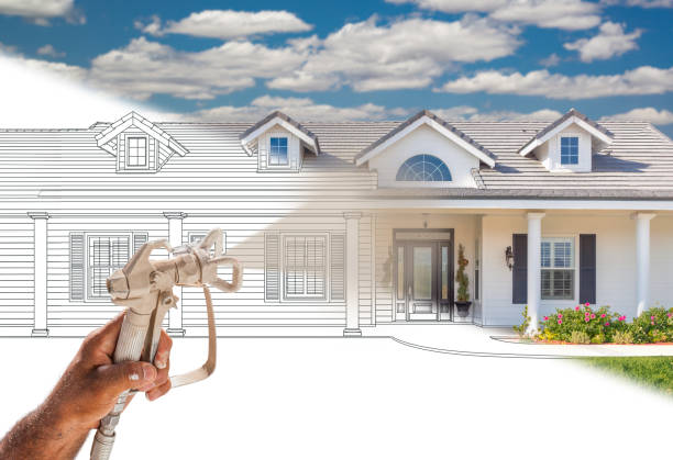 istock Professional Spray Painter Holding Spray Gun Spraying New House Over Design Drawing. 2150855861