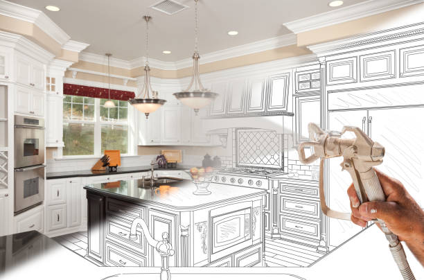 istock Professional Spray Painter Holding Spray Gun Spraying Renovated Kitchen Over Design Drawing. 2150855951