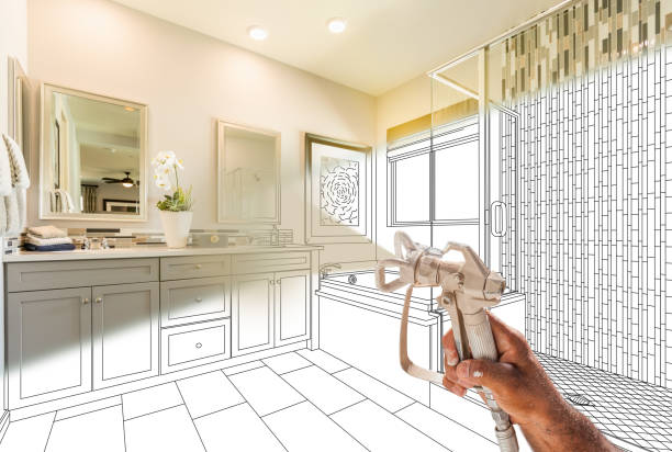 istock Professional Spray Painter Holding Spray Gun Spraying Renovated Bathroom Over Design Drawing. 2150855970
