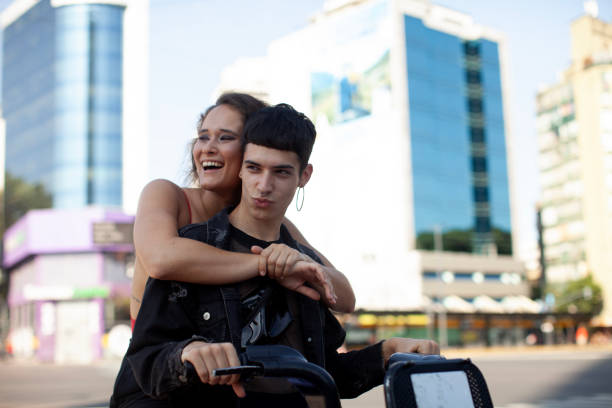 Young friends having fun riding bicycle in Buenos Aires city