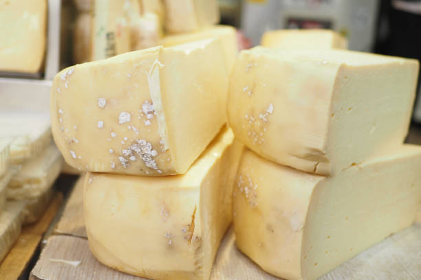 A close-up shot of melting raclette cheese being served at Berlin's Christmas market. Highlighting the warmth and flavor of holiday street food.