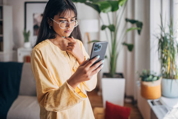 Focused woman looking at smartphone screen