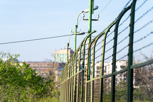 A fence covered with barbed wire to prevent trespassing