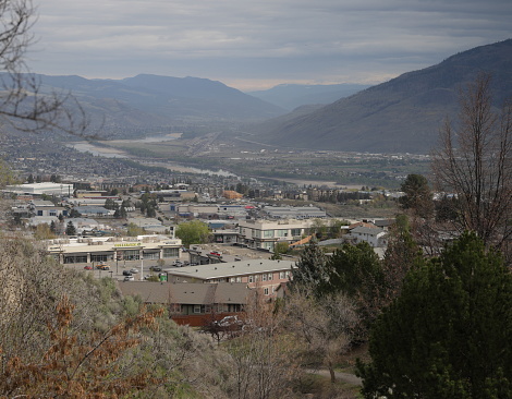 Kamloops, Canada - April 25, 2024: View of the hillside businesses and residences of the Aberdeen neighbourhood. The Thompson River Valley in the background. Spring morning in the Thompson-Nicola Regional District.
