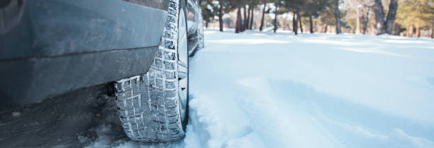 istock Car tires on winter road 2150865539