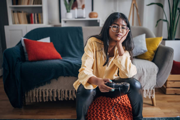 istock Woman gaming, showing contemplative face 2150865597