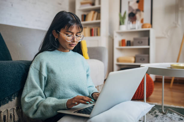 istock Woman working on laptop in a bright room 2150865939