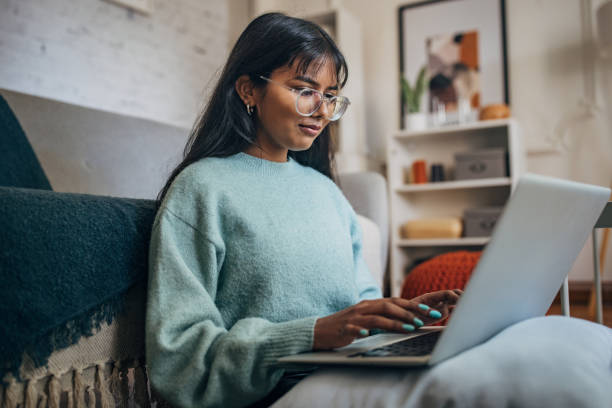 istock Engrossed in work on laptop at home 2150866114