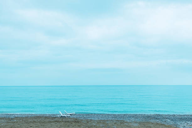 Morning view from untouched sandy beach over blue water of Tyrrhenian Sea at Campofelice di Rocella, Sicily, Italy.