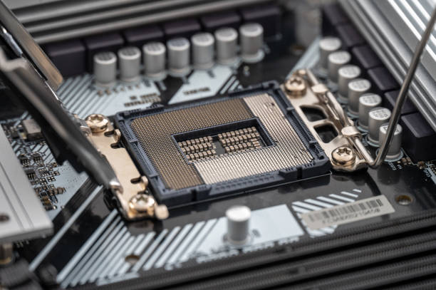 istock High-resolution image of an open CPU socket on a modern motherboard, detailing the intricate pin arrangement and nearby components. 2150866785
