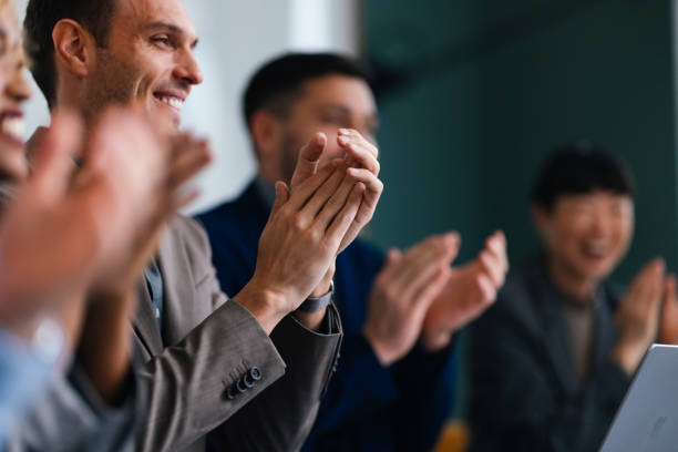 Businesspeople Clapping Hands During A Business Seminar