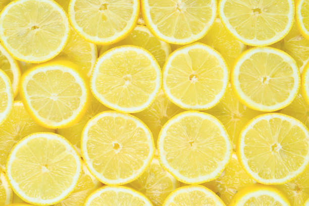 istock A slices of fresh juicy yellow lemons.  Texture background, pattern. 2150874675
