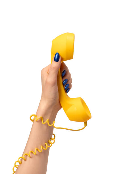 istock Yellow handset in woman hand isolated on white. Copy space. 2150874703