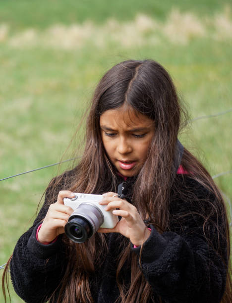istock Young girl photographing with camera 2150876446