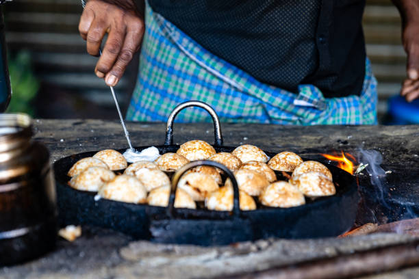 istock Village Men Whip Up Paniyaram 2150877431