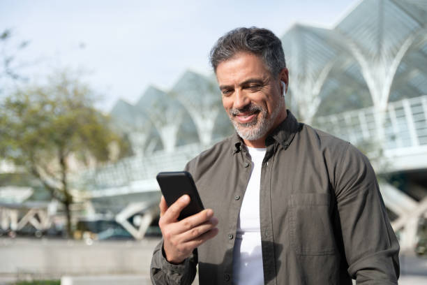 istock 40s mature confident busy businessman entrepreneur using cellphone mobile phone for talking with family, business partners. Successful mid age man investor communicating on smartphone standing outdoor 2150877778