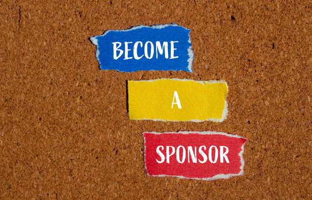 istock Become a sponsor words written on ripped paper pieces with brown background 2150877966