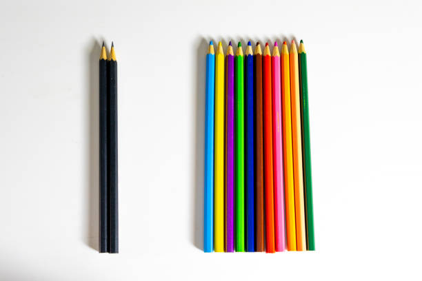 A Group Of Colored Pencils Separated From Black Pencils