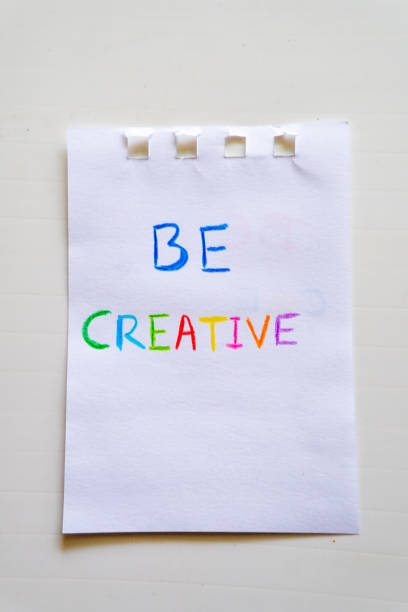 istock A Piece Of Paper That Says Be Creative near a notepad 2150879022