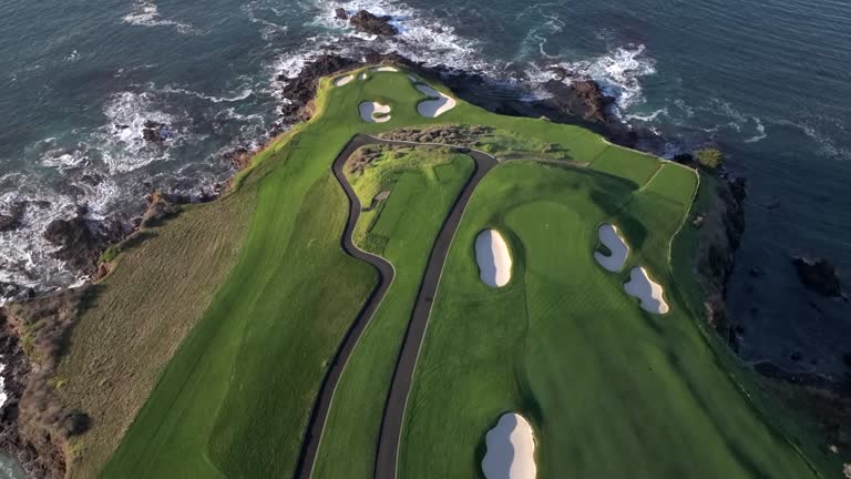 Iconic Pebble Beach golf course at the 6th and 7th hole fairway, picturesque aerial