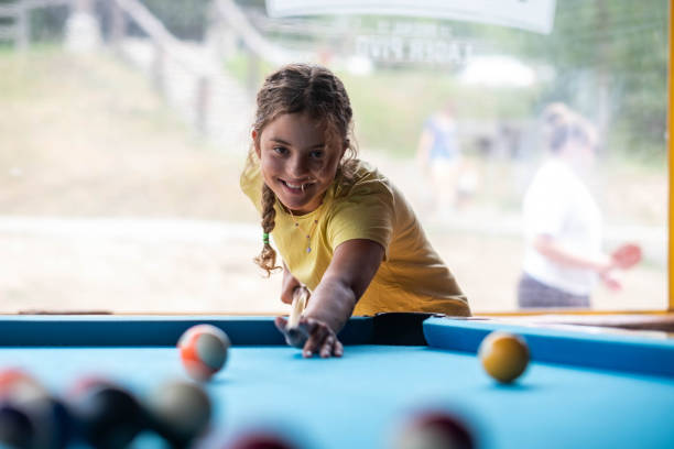istock girl plays billiards 2150881642
