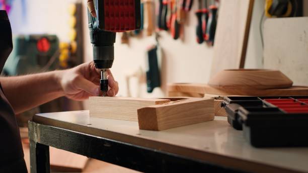 istock Manufacturer in assembly shop picking screw from tool box 2150881891
