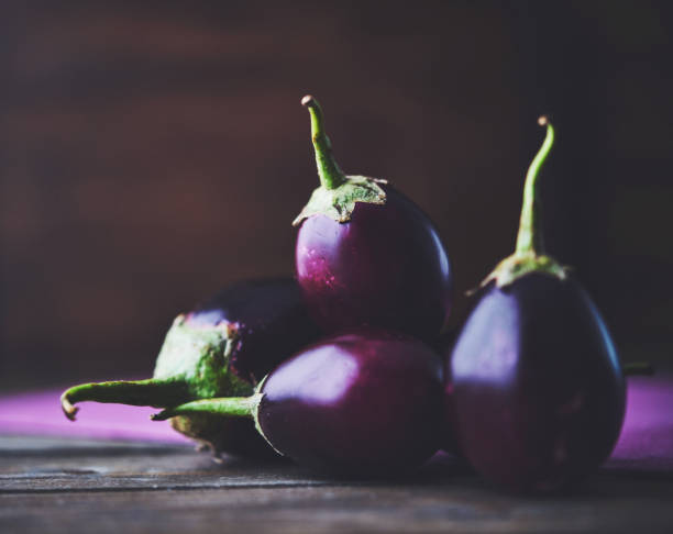 istock Fresh organic eggplant on a rustic wood table with space for copy 2150881983