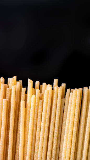 istock Background on kitchen of dry spaghetti ready to be cooked 2150885222