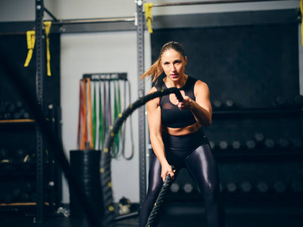 istock Woman in a Gym Training with Ropes 2150886029