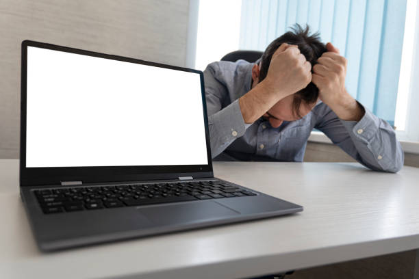 istock an empty white screen for text and design on a modern laptop standing in the workplace. Copy space. Stressed businessman working on laptop 2150889914