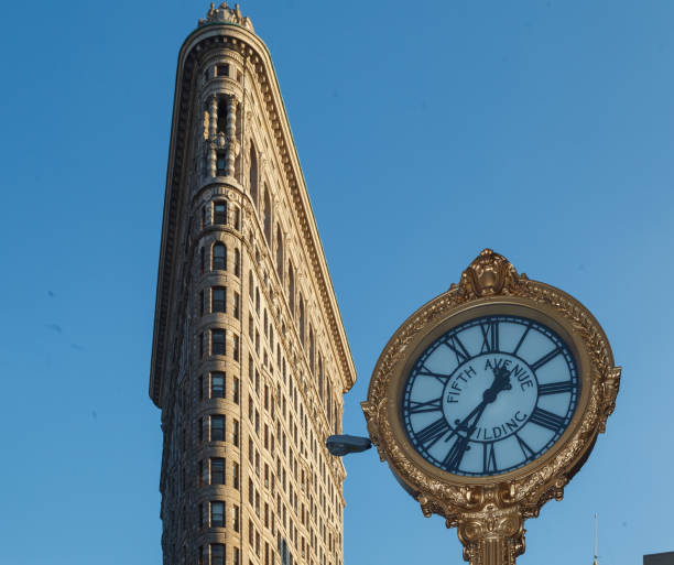 Detail of the 5h avenue building clock and the top facade of the Flatiron Building in Manhattan, New York City