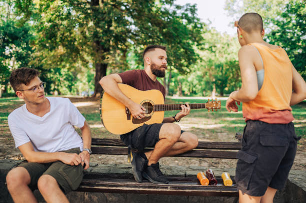 istock Group of environmentalist gathered in park and playing guitar. 2150890325