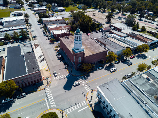 istock Camden Clock Tower on Broad Street intersection in South Carolina. Sparse traffic on the road junction in historic Camden, SC. Aerial cityscape view 2150891754