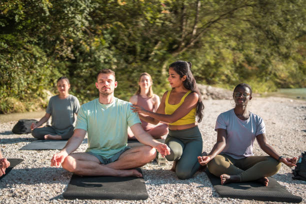 istock Indian Female Yoga Instructor with Diverse Group 2150891766