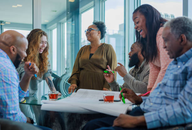 istock Successful teamworking. Afro-American coworkers discussing working project together and drinking tea. 2150891995