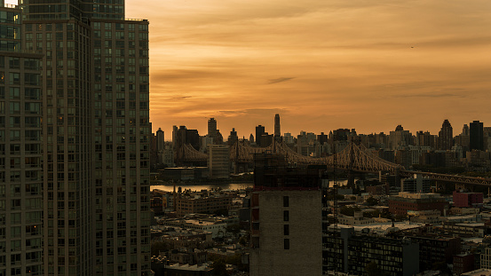 Queensboro Bridge over the East River with Roosevelt Island and Upper East Side Manhattan, seen from Long Island City, Queens at sunset.