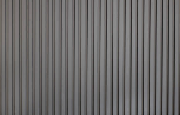 Grey wall panel. Seamless background texture of grey painted wood paneling, metal siding, ribbed background textures.