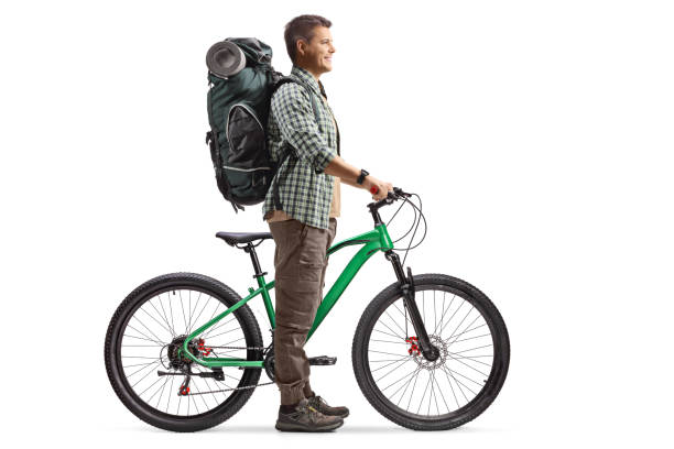 istock Full length profile shot of a man with a backpack standing with a bicycle 2150896378