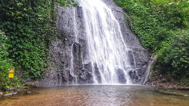 istock A stunning waterfall cascading down a rocky cliff surrounded by lush green vegetation 2150897971
