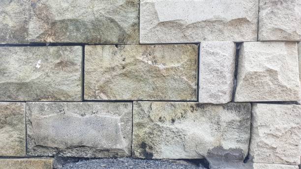 istock A close-up view of a wall made from large, irregularly shaped stone blocks, showcasing their texture and natural color variations. 2150898568