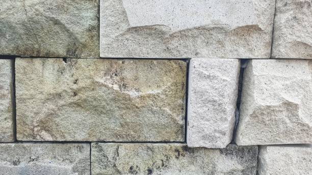 istock A close-up view of a wall made from large, irregularly shaped stone blocks, showcasing their texture and natural color variations. 2150898569