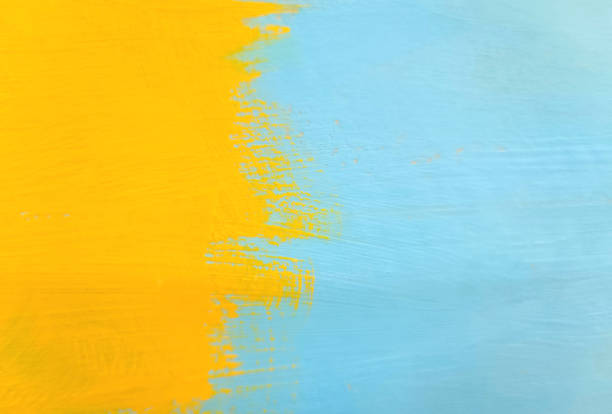 istock yellow blue paint brush on wood 2150901786