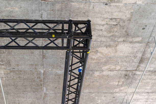 istock A black steel structure is installed in the concrete ceiling to support and mount audio and lighting devices. 2150902286