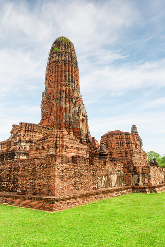 Awesome tower (prang) of Wat Phra Ram in Ayutthaya, Thailand. Scenic ruins of the Buddhist temple in the ancient city of the Ayutthaya Kingdom (Siam). Thailand is a popular tourist destination of Asia