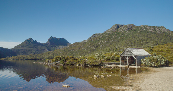 the old boat shed at dove lake with cradle mt in the distance on a calm summer morning at cradle mountain national park of tasmania, australia