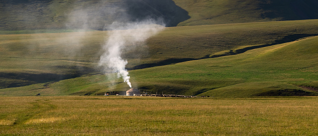 Traditional nomad dwelling - a yurt at the foot of the plateau hills on a summer morning