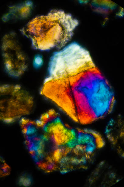 istock Brilliant, glowing grains of sand from California under the microscope. 2150905678
